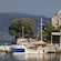 2 small wooden boats docked near 2 waterfront buildings